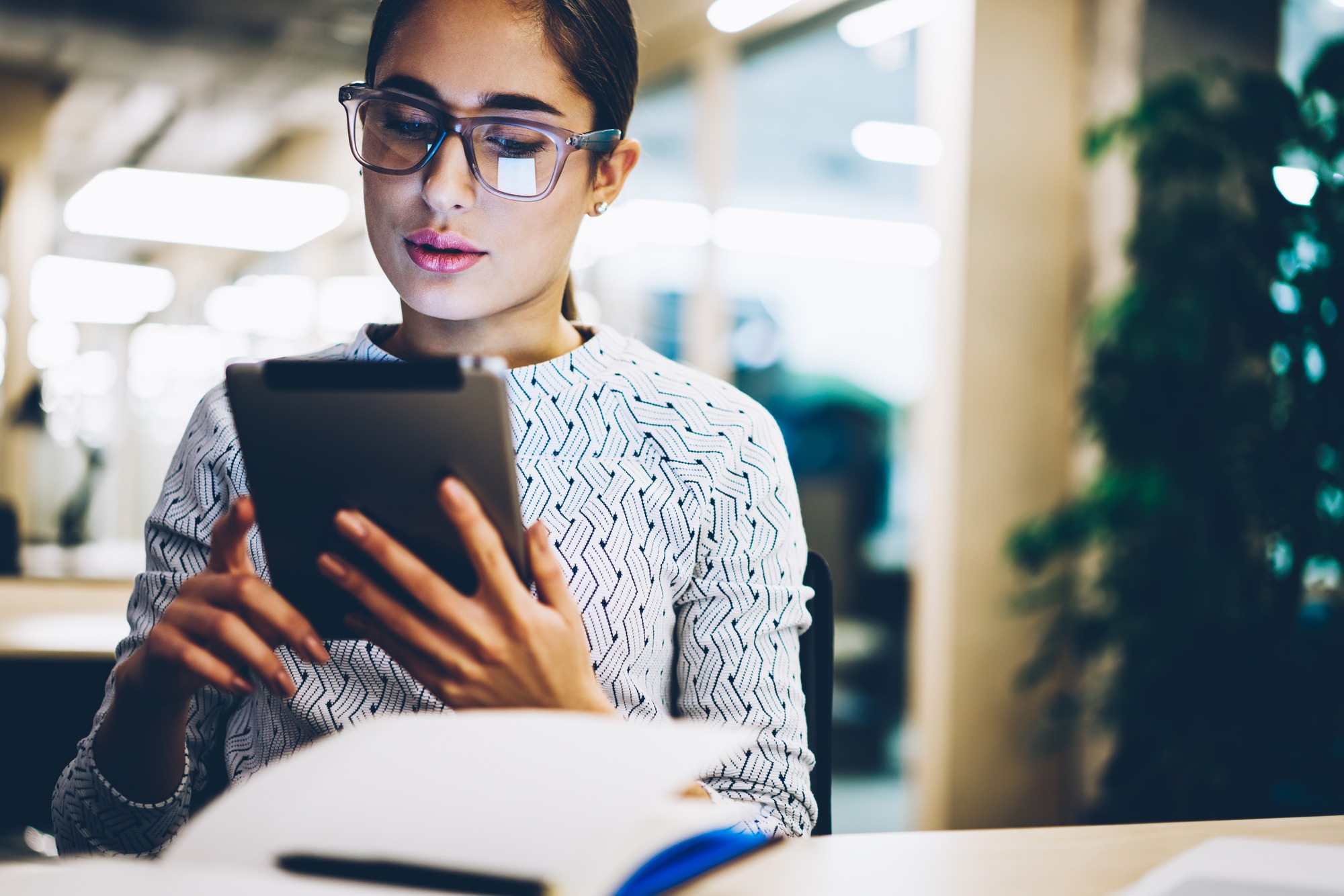Pensive young businesswoman reading